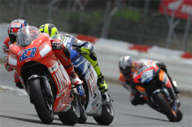 Stoner back in front but it's still anyone's race... And it was this close for ten laps