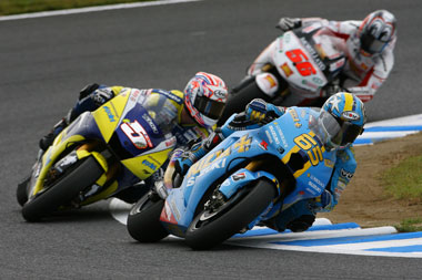 Capirossi, Edwards and Nakano in the biggest real action of the race. All race long...