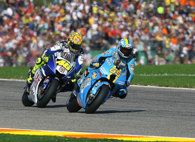 Old mates Rossi and Capirossi swap positions. Check the size of the crowd...