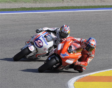And the crowd...weren't that impressed. Stoner duffs up local hero Pedrosa on the second corner. Cool paint job on the Honda, though.