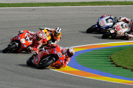 Stoner leading Hayden and Pedrosa on lap two. But take a look at what's about to go down just behind them. It ain't gonna be pretty... (Pic: Ducati)