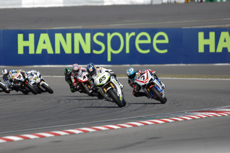 Johnny Rea leads Checa and Haga into the first corner...